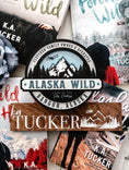 Load image into Gallery viewer, Officially Licensed K.A. Tucker "Alaska Wild Round Sign" created by FireDrake Artistry®
